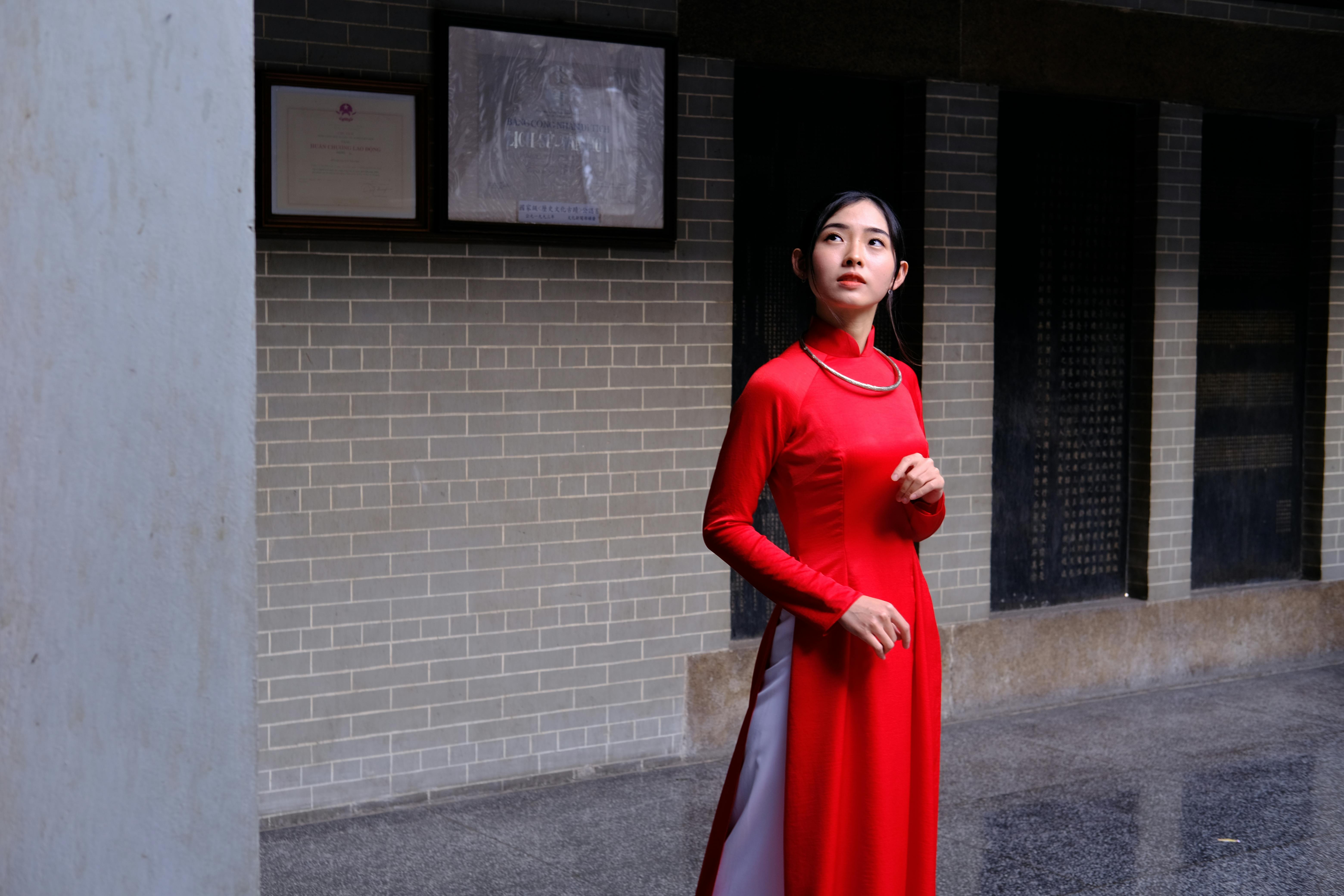 woman in a red dress looking up