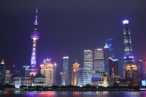 Free Vibrant Shanghai skyline at night featuring the Oriental Pearl Tower and Shanghai Tower. Stock Photo