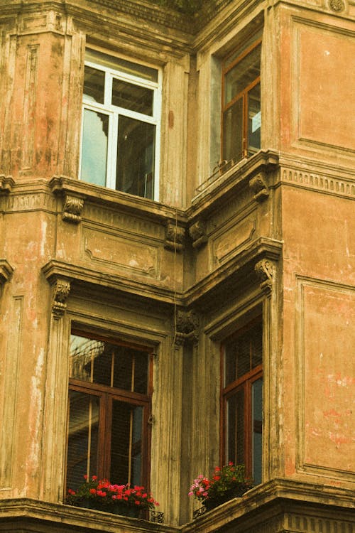 Free Old Building with Glass Windows and Faded Facade Stock Photo