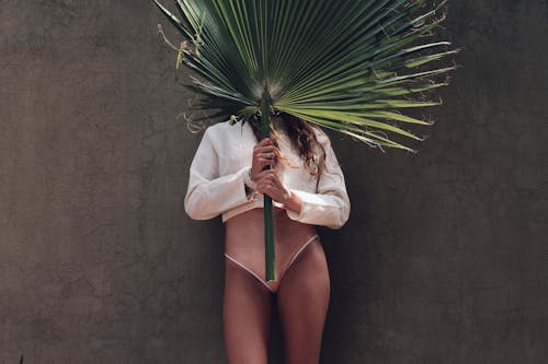 Woman Holding a Fan Palm