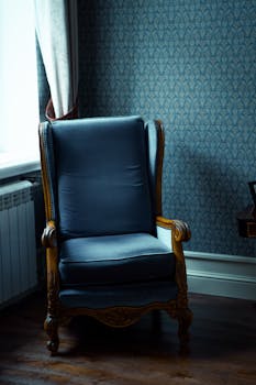 An ornate vintage armchair sits in a stylish, beautifully decorated interior room, exuding class.
