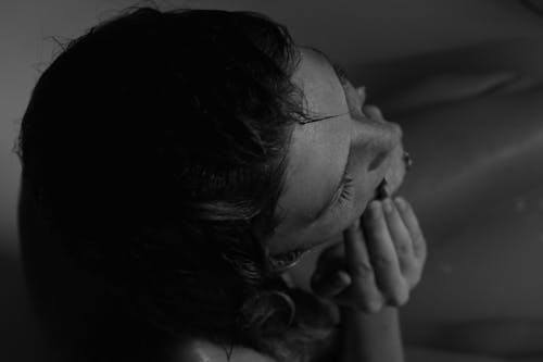 Grayscale Photo of a Woman in a Bathtub