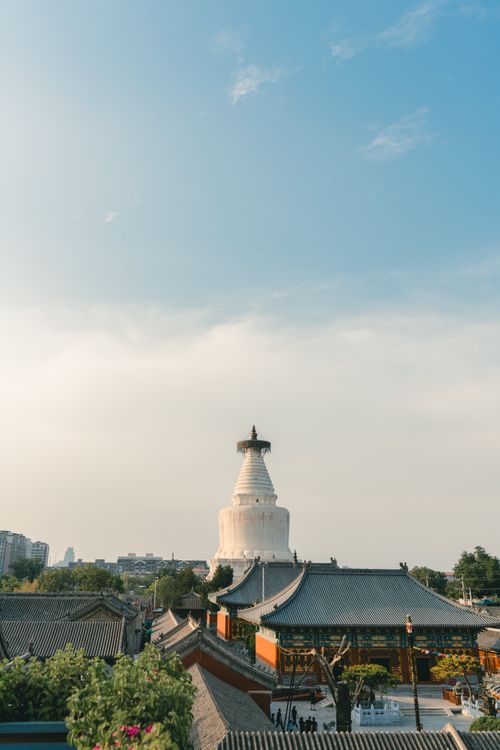 Free A serene landscape featuring a historic white pagoda temple against a clear sky, perfect for travel inspiration. Stock Photo