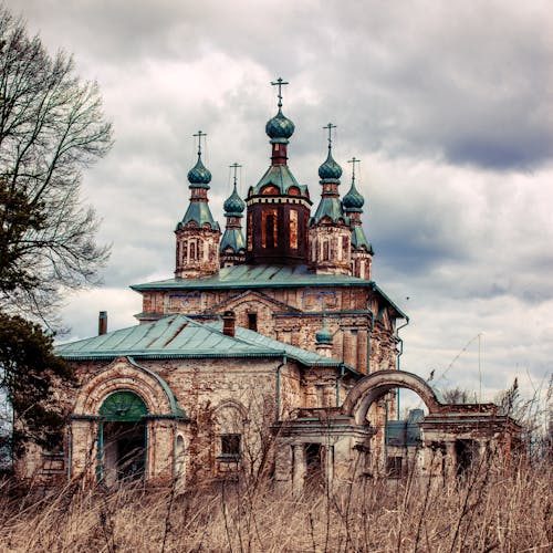 Abandoned Church Building in Brown Grass Field