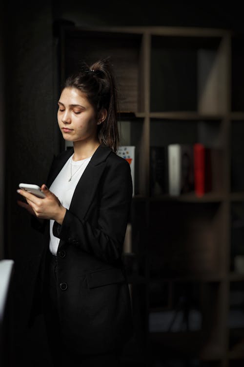 Photo of a Woman Looking at Her Smartphone