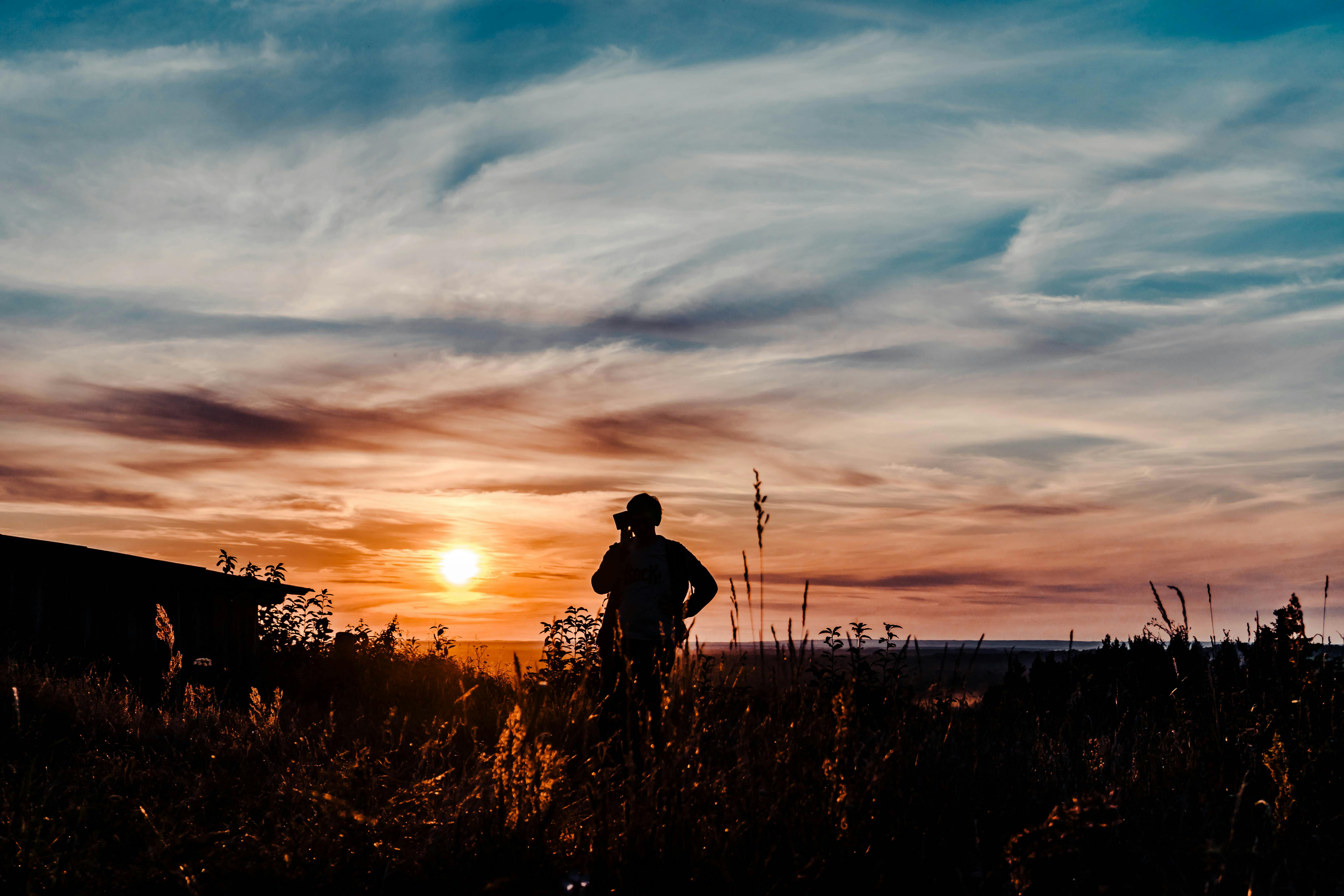 A friendly insurance agent explains a policy to a client across a desk, representing the process of understanding Massachusetts insurance plans.