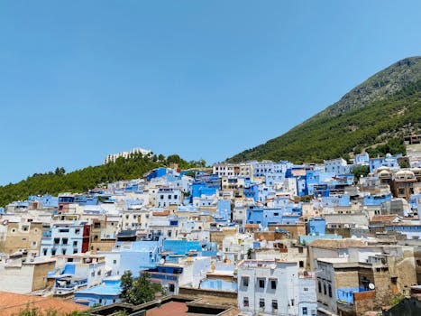 Explore the vibrant, blue-painted townscape of Chefchaouen under a clear sky.