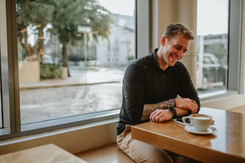 Woman Using Smartphone Inside Coffee Shop · Free Stock Photo