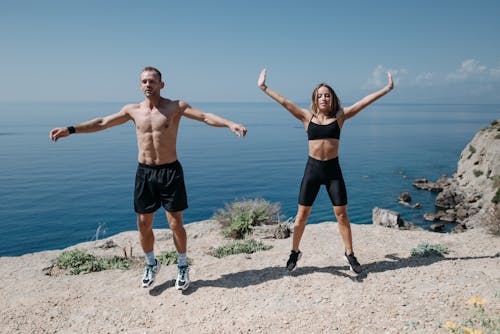 Man and Woman Working Out on the Cliff