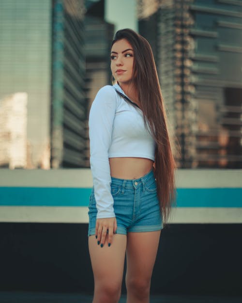 Woman in White Long Sleeve Shirt and Blue Denim Shorts