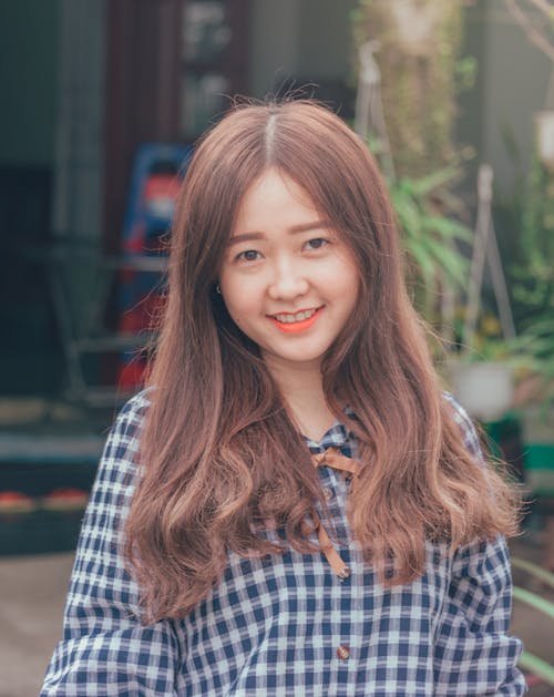 Photo of Woman Wearing White and Blue Button-up Top