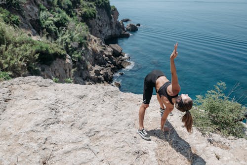 Free Person Doing Exercise on a Cliff Stock Photo