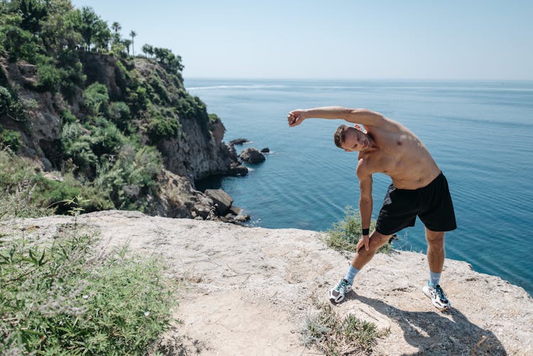 Man In Black Shorts Stretching