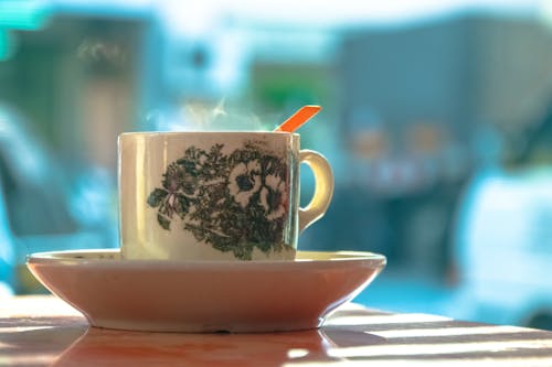 White and Green Ceramic Mug on White Ceramic Plate