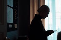 Man in Black Jacket Standing Near Window