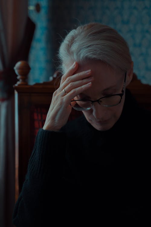 Elderly Woman in Black Dress Feeling Emotional