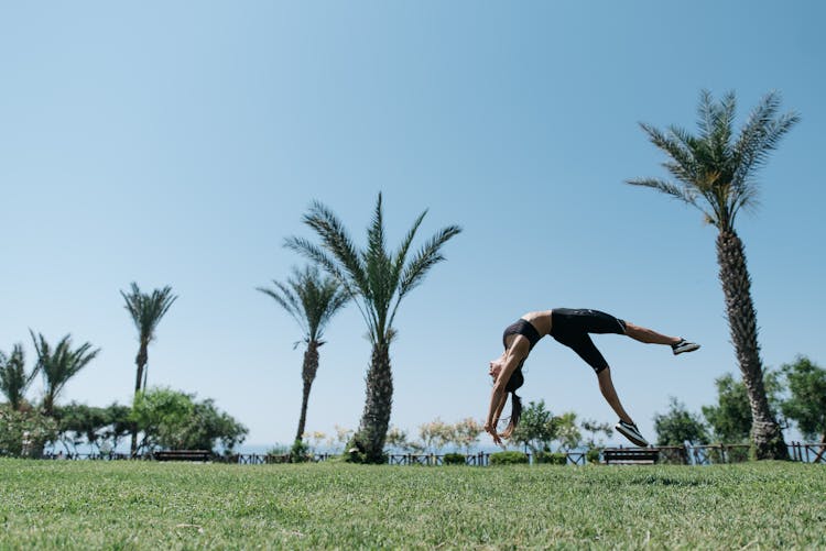 A Woman Performing A Backflip