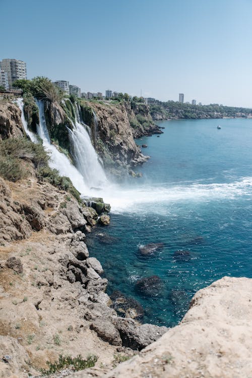 A Waterfall Cascading Down from the Coastal Cliff