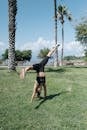 Woman in Black Sports Bra and Black Shorts Doing Yoga