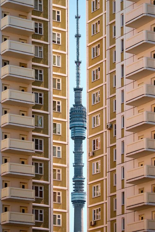 Free View of Ostankino Tower between apartment buildings in Moscow, showcasing urban design. Stock Photo
