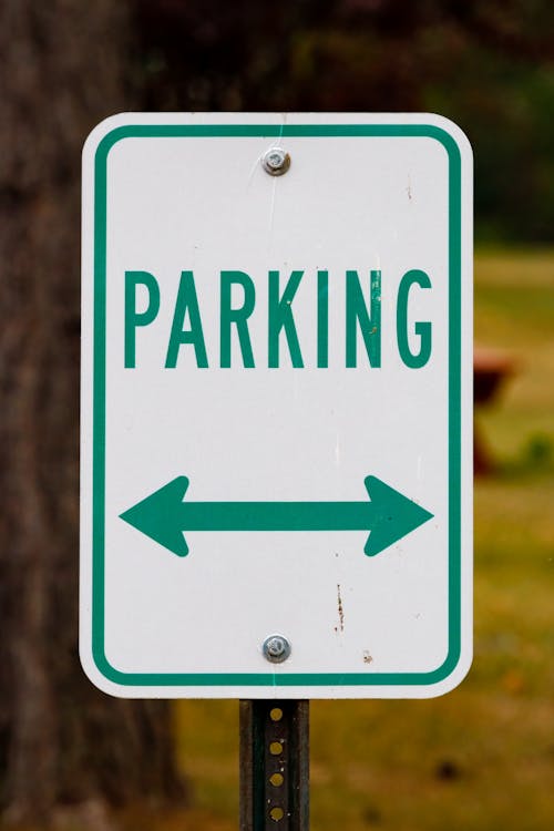 White and Green Parking Sign