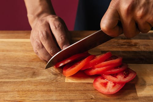 A person Slicing Tomatoes