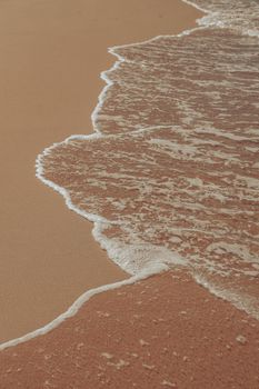 Serene beach with rolling waves and soft sand, perfect for relaxation and nature themes.