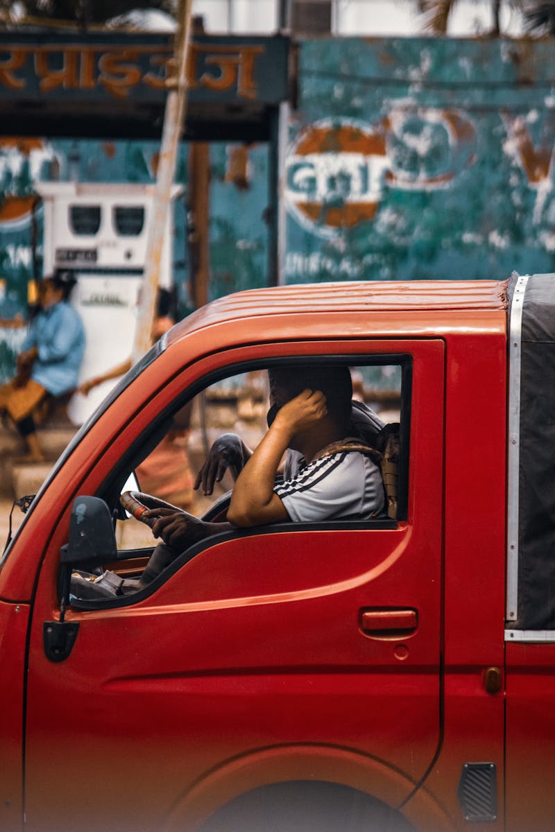 Woman in Black Shirt Driving Red Car