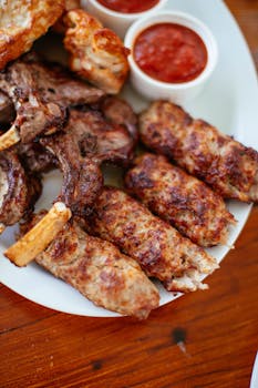 Tasty grilled lamb chops and minced meat skewers served with red sauce.