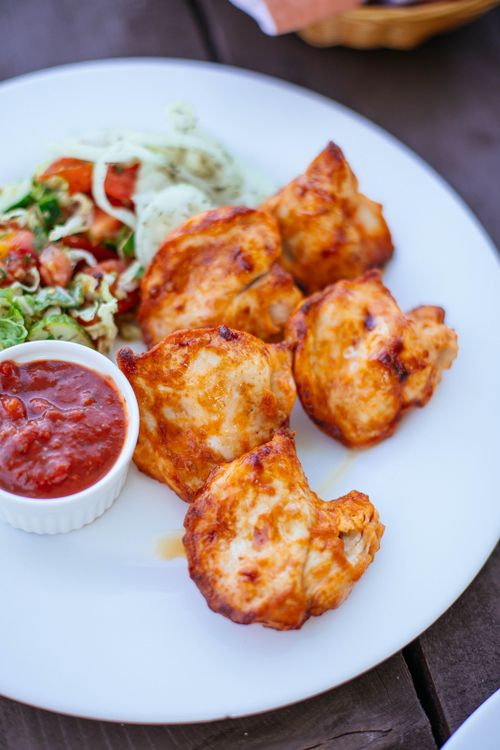 Free Grilled chicken served with fresh salad and salsa on a white plate. Stock Photo
