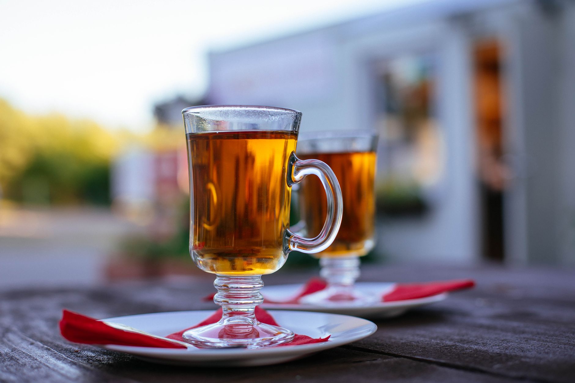 Hot Buttered Rum in glass mug with whipped cream and cinnamon stick