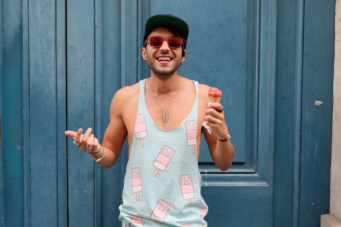 Person in Teal Ice Cream Print Tank Top Holds Ice Cream