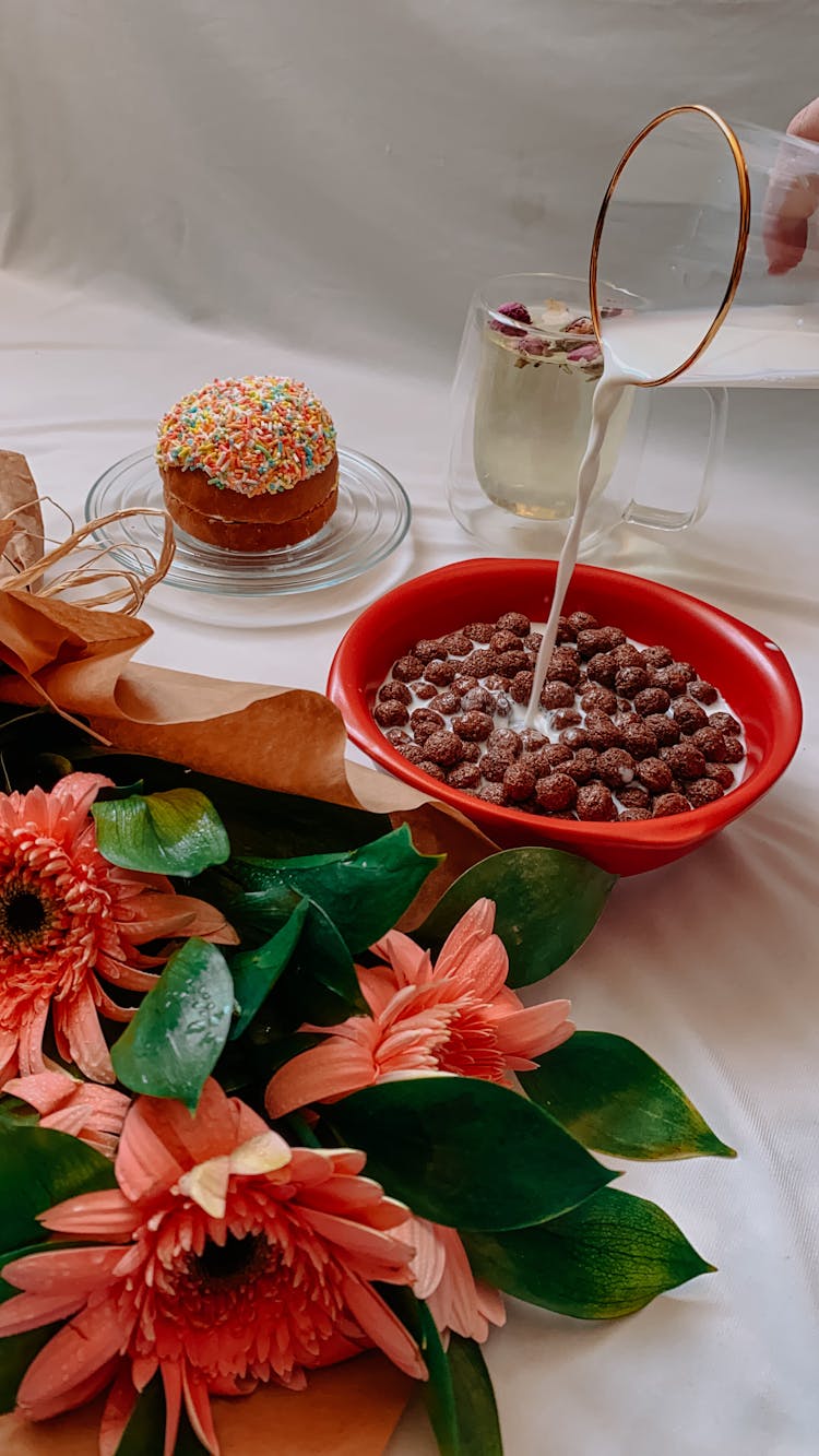 Pouring Milk To Bowl With Cornflakes