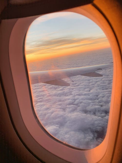 Free A View of an Airplane Wing Above the Clouds  Stock Photo