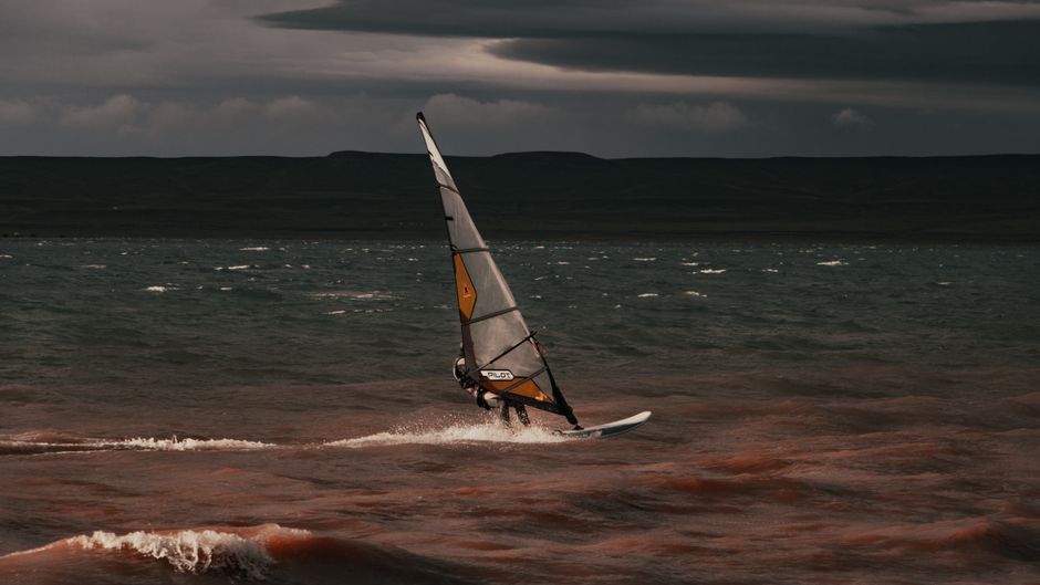 Cursor AI vs Windsurf: Coding Flow Showdown (2026) Experience the thrill of windsurfing against dramatic skies on choppy seas.