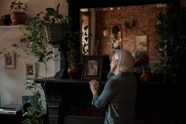 Elderly Woman Looking At A Picture Frame