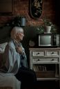 Woman in White and Blue Stripe Dress Shirt Sitting on Chair