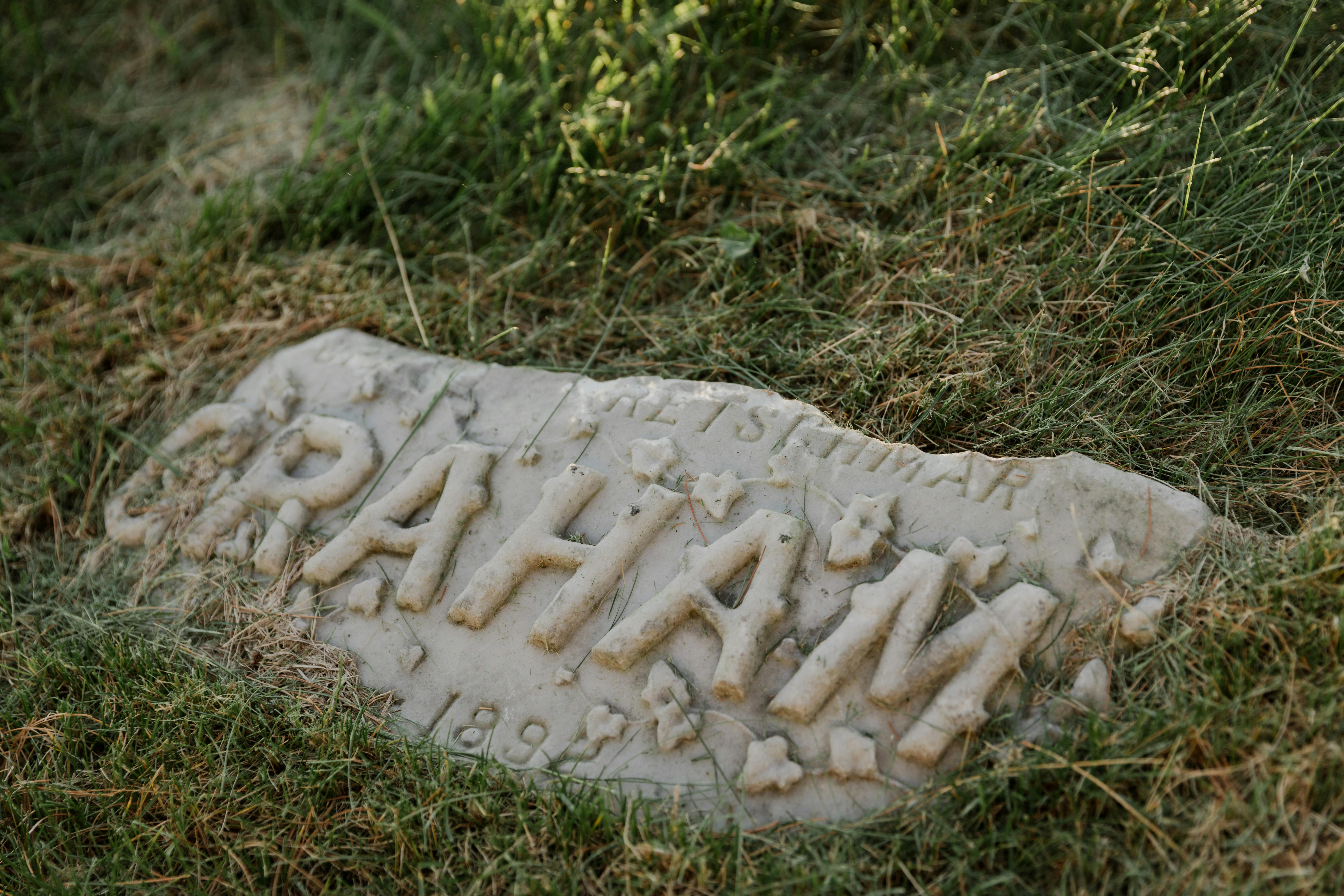 a gravestone on green grass