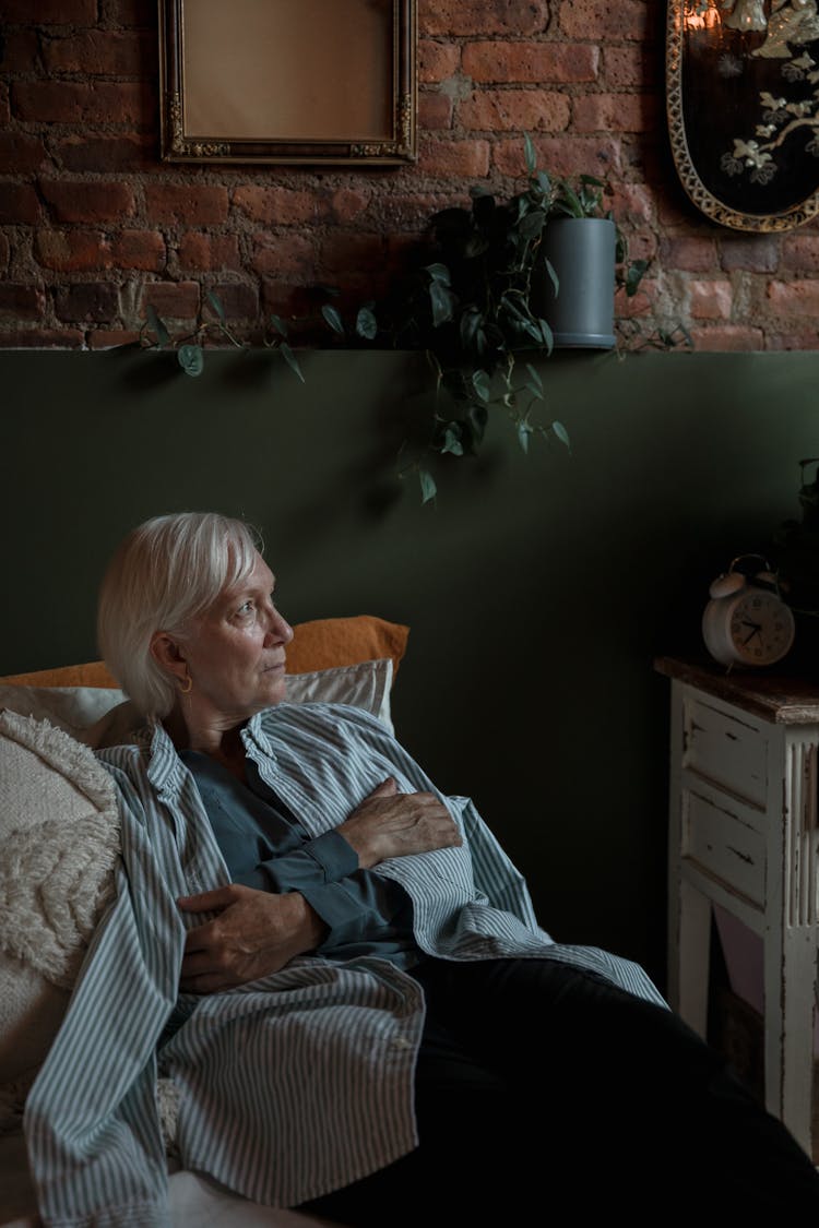 An Elderly Woman Looking Away While Her Arms Are Crossed