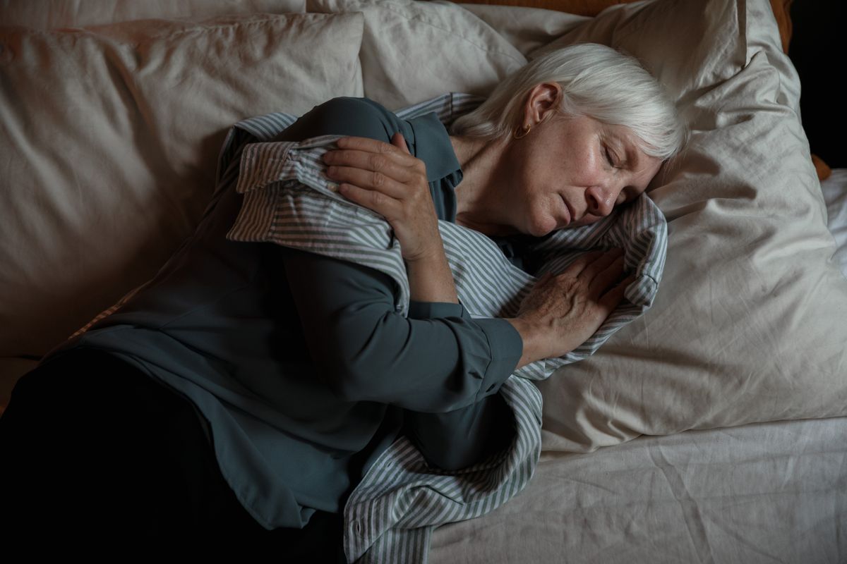 Senior woman sleeping peacefully in a cool bedroom