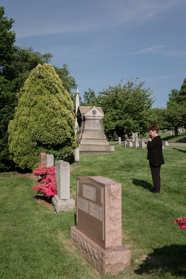 Woman Standing Near Headstones