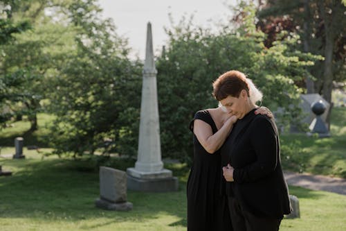 Free Elderly Women Grieving at a Cemetery Stock Photo