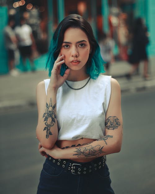 A Woman in White Crop Top Standing on the Street