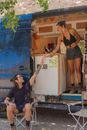 Woman in Black Tank Top and Black Shorts Holding White Plastic Bottle
