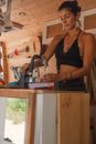Woman in Black Spaghetti Strap Top Holding Gray and Black Power Tool