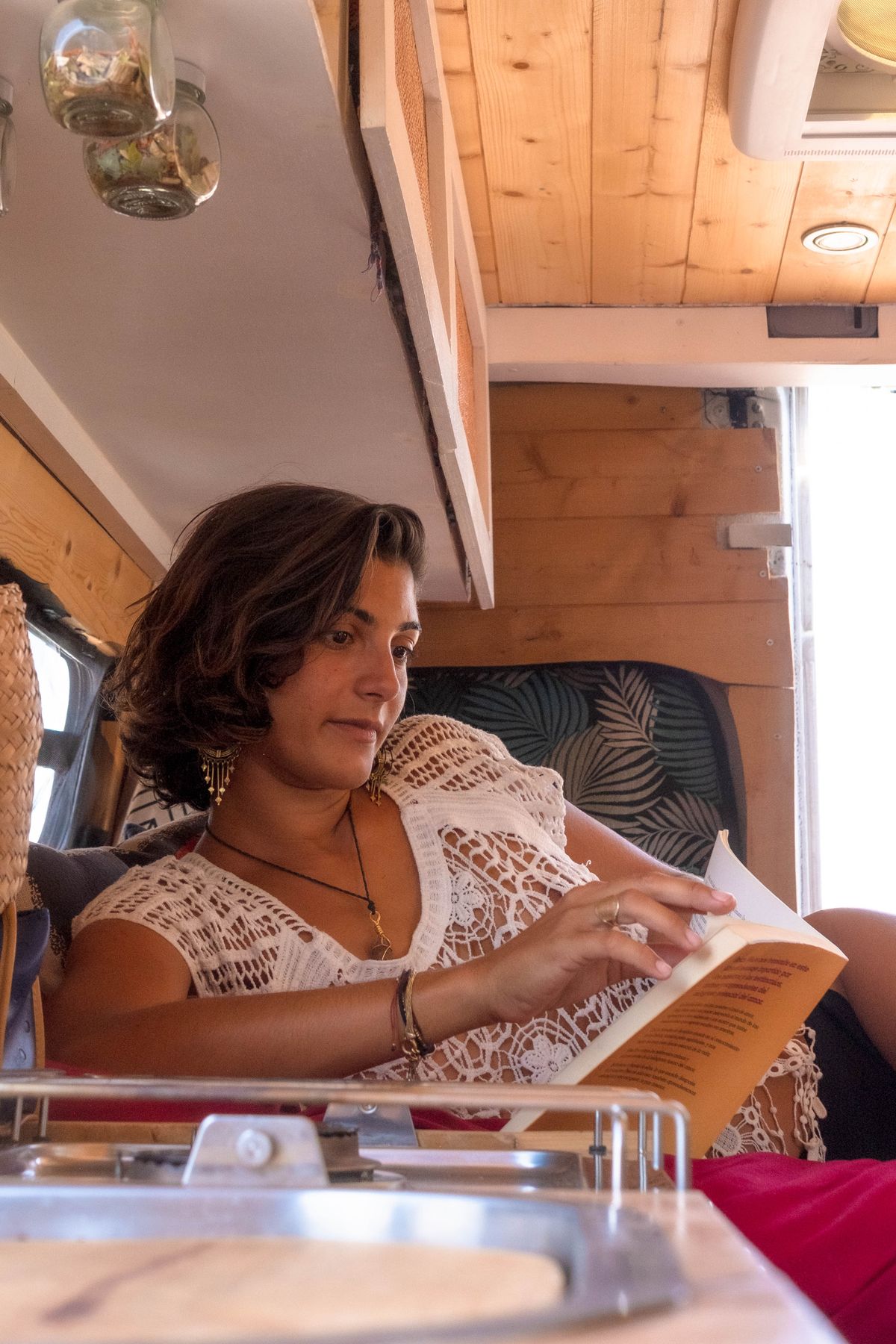 Guest reading in a cozy camper lounge