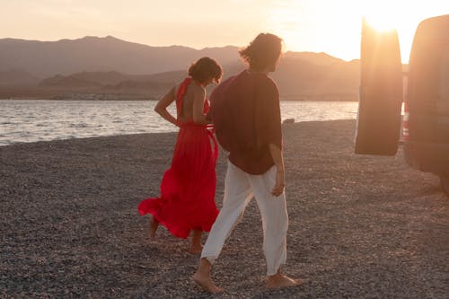 Romantic Couple Walking on the Beach during Sunset
