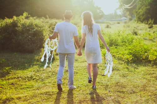 Couple Holding each other's Hands while Walking