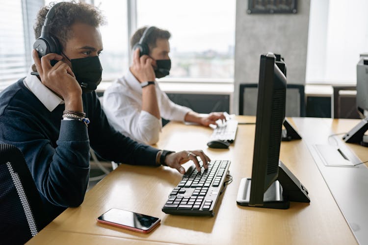 Men Using Computers In The Office