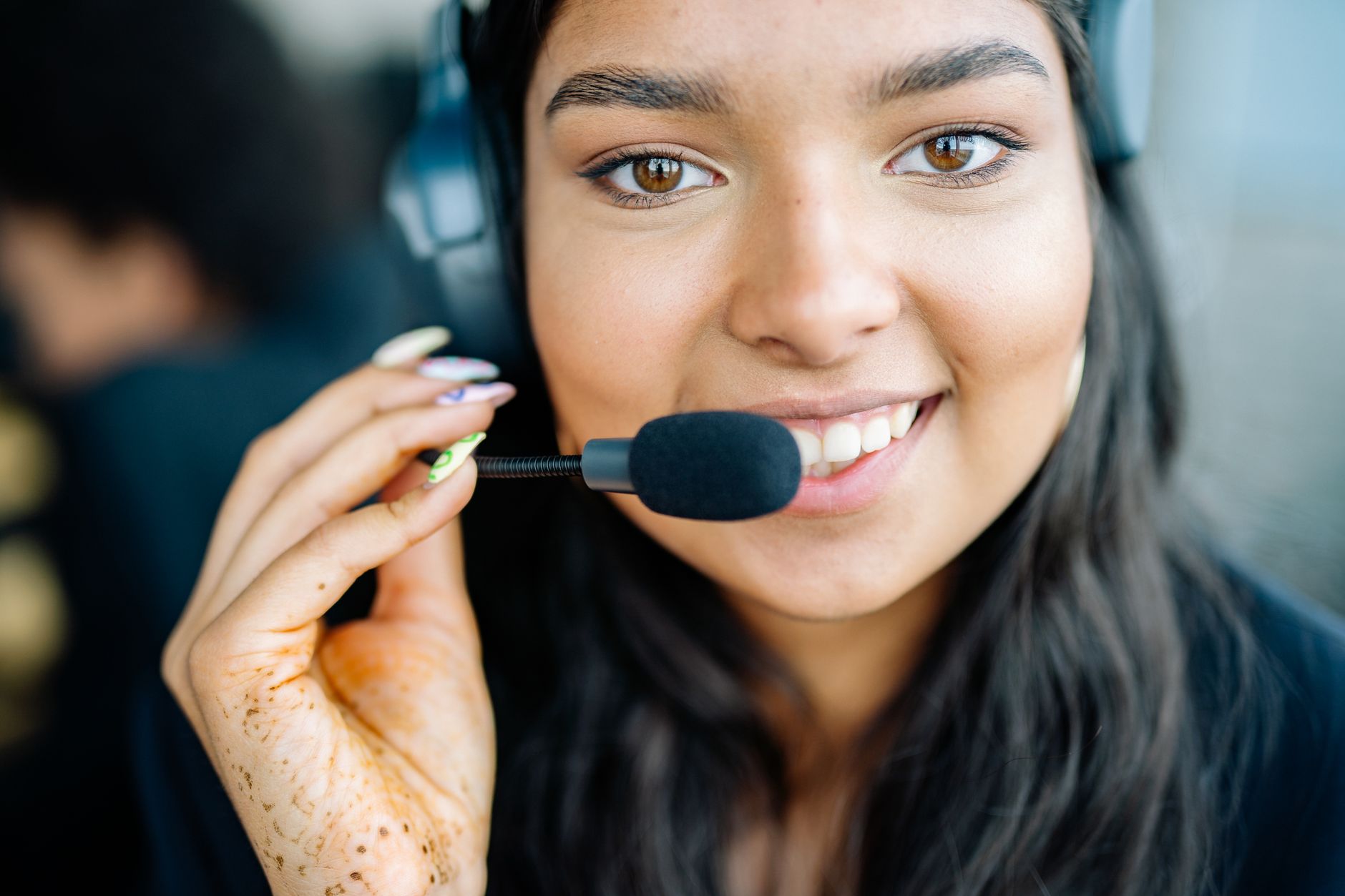 Charming call center operator with a headset, smiling while assisting customers.